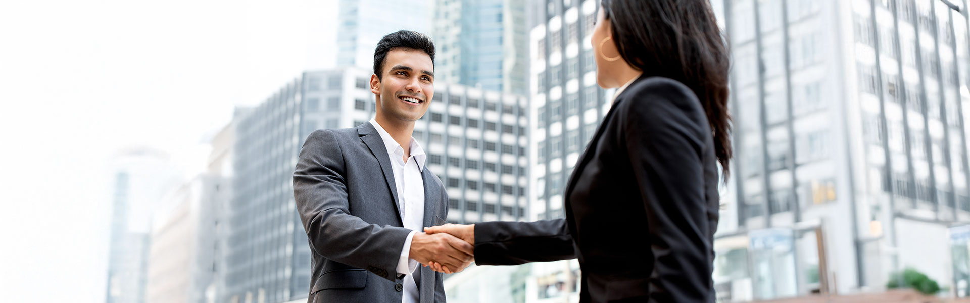 Indian and Sri Lankan professionals shaking hands, symbolizing economic partnership and investment in Port City Colombo.